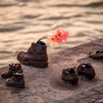 shoes with flowers in them by a river
