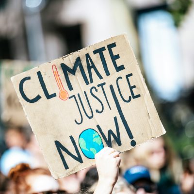 Sign reading 'climate justice now'