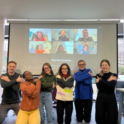 The Agulhas team doing the 'embracing equity' pose for IWD